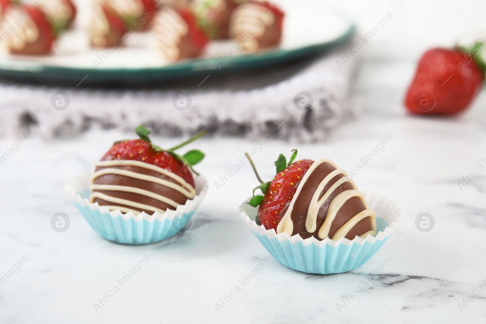 Photo of Tasty chocolate dipped strawberries on table, closeup