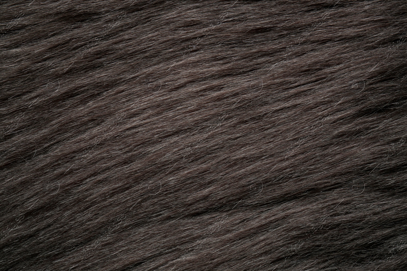 Photo of Beautiful dark faux fur as background, top view