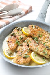 Photo of Delicious chicken piccata in pan on table, closeup