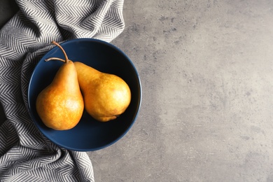 Photo of Flat lay composition with ripe pears on grey background. Space for text