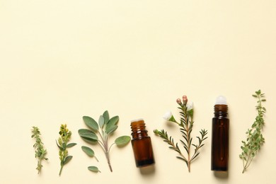 Photo of Bottles of essential oils and different herbs on beige background, flat lay. Space for text
