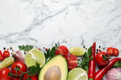 Fresh guacamole ingredients on white marble table, flat lay. Space for text