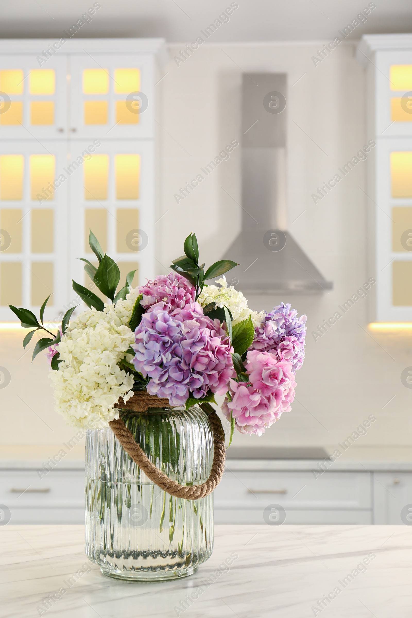 Photo of Bouquet with beautiful hydrangea flowers on white marble table