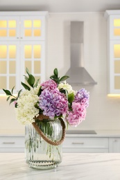 Bouquet with beautiful hydrangea flowers on white marble table