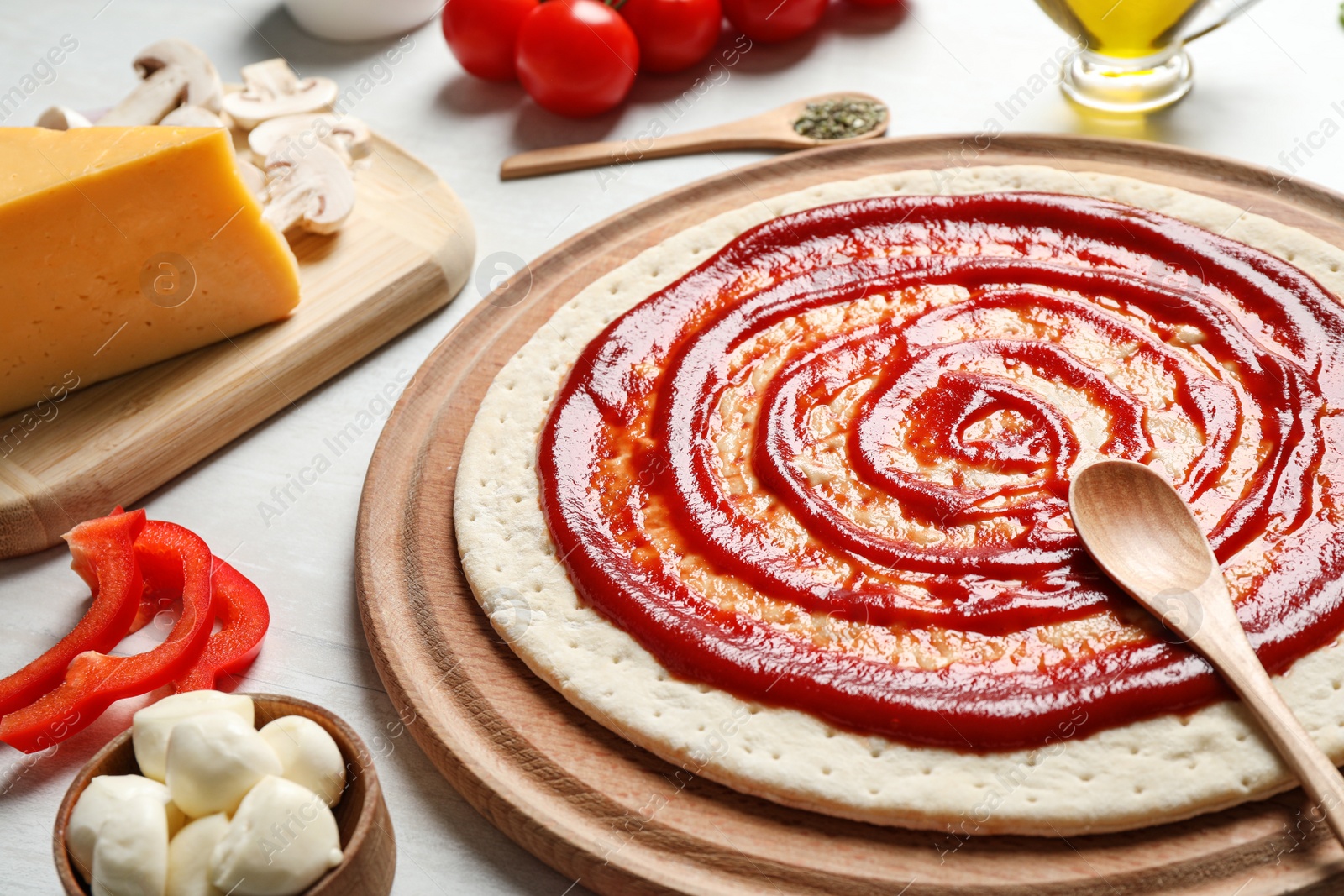 Photo of Composition with pizza crust and ingredients on table, closeup