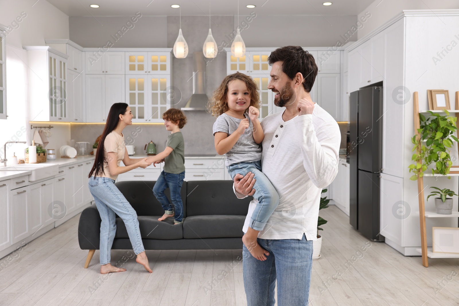 Photo of Happy family dancing and having fun at home