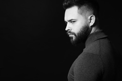 Photo of Portrait of handsome bearded man on dark background, space for text. Black and white effect