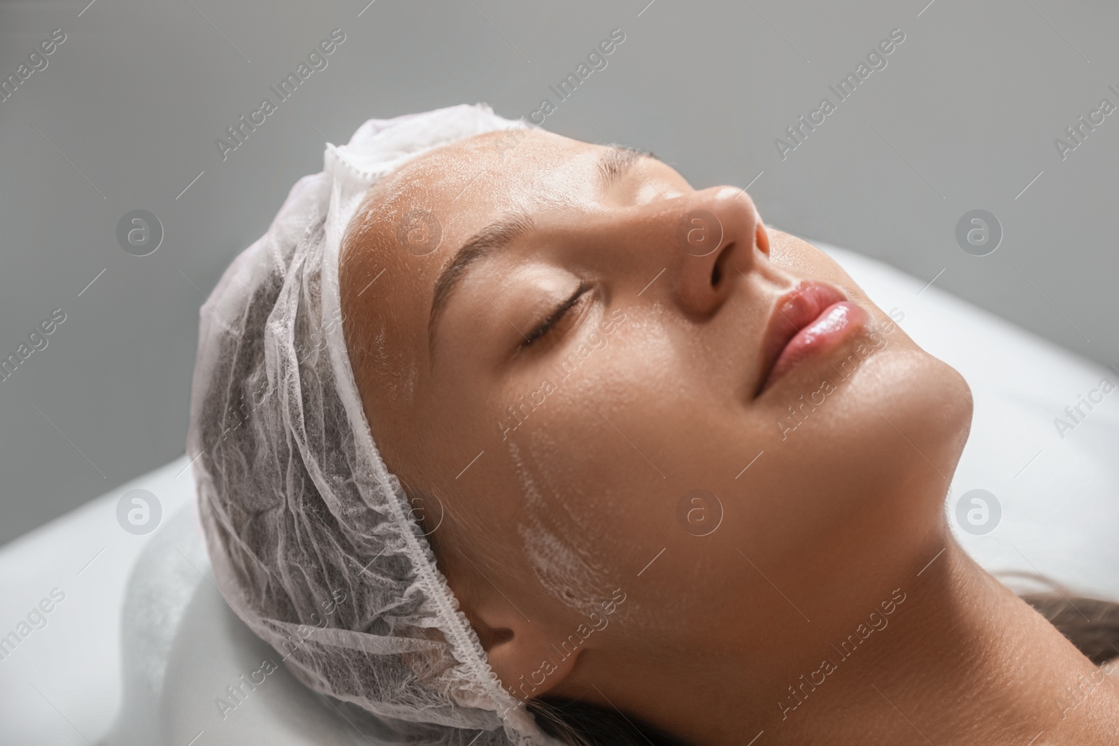 Photo of Beautiful woman lying on table in spa salon