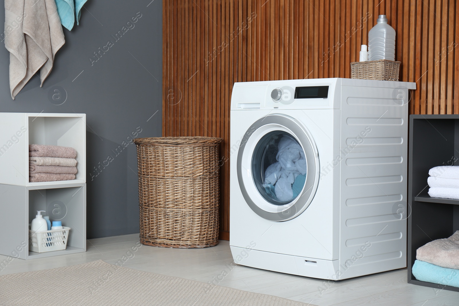 Photo of Washing of different towels in modern laundry room