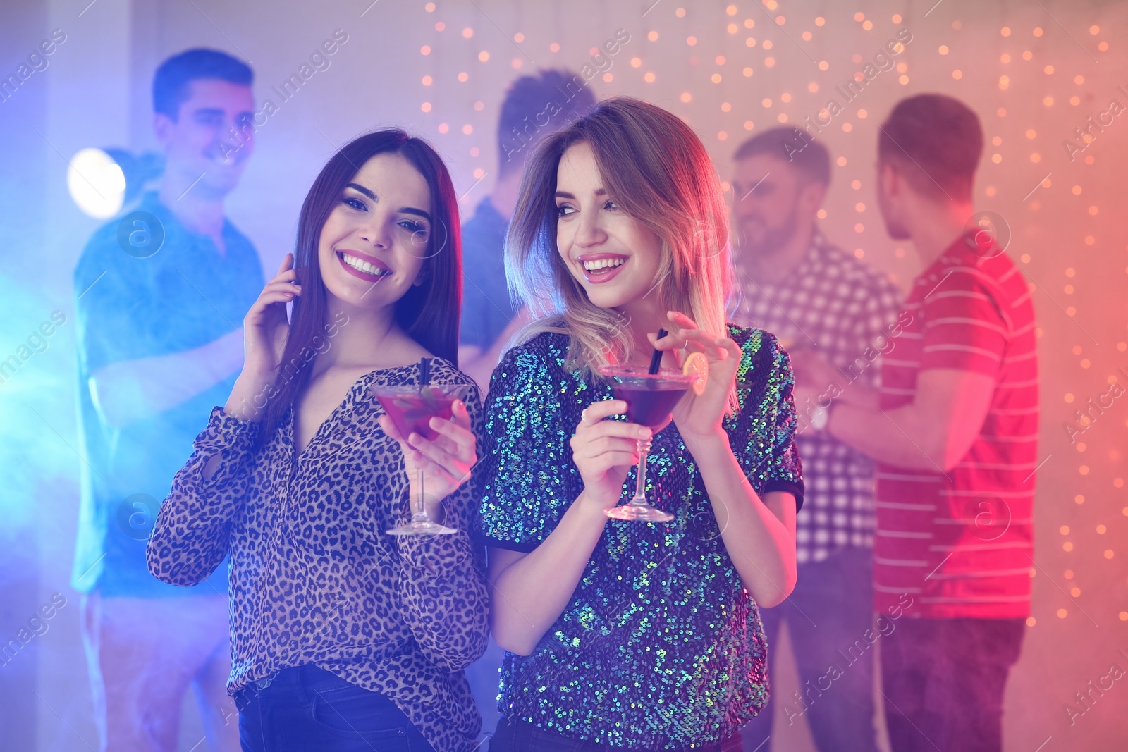 Photo of Beautiful young women with martini cocktails in bar