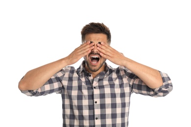 Young man being blinded on white background