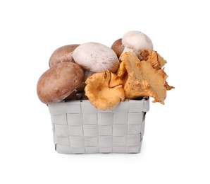 Photo of Basket with different mushrooms isolated on white