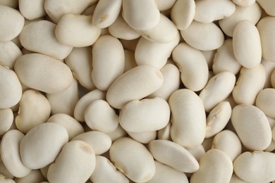 Pile of uncooked white beans as background, closeup