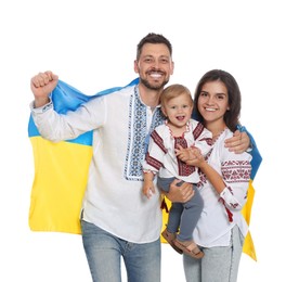 Photo of Happy family in national clothes with flag of Ukraine on white background