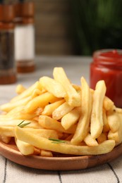 Photo of Delicious french fries served with sauce on table, closeup