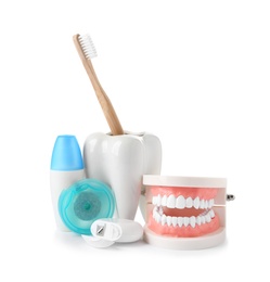 Photo of Composition with model of oral cavity and dental care items on white background. Healthy teeth