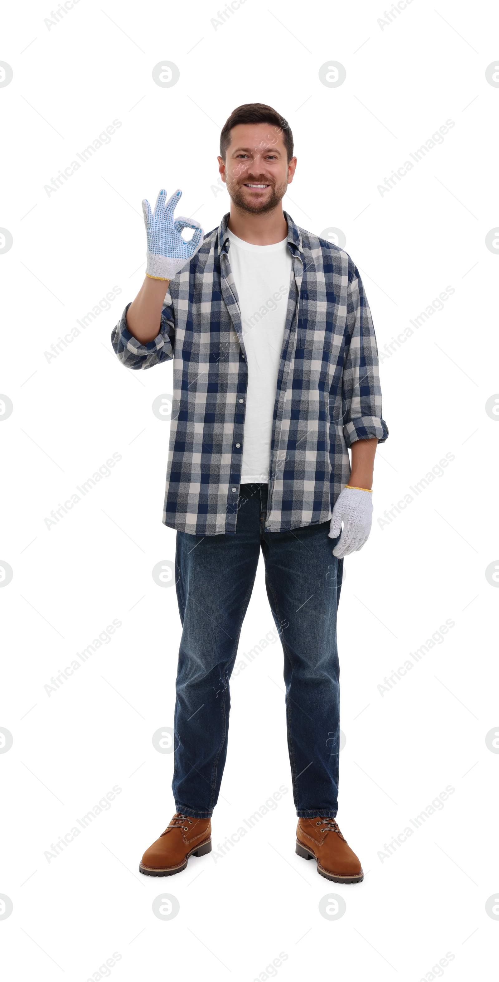 Photo of Happy man in gloves showing ok gesture on white background