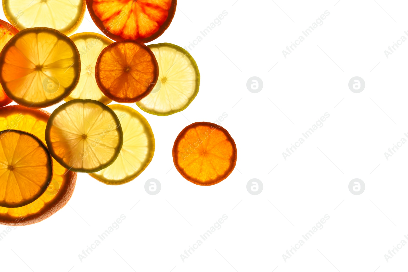 Photo of Illuminated slices of citrus fruits on white background, top view