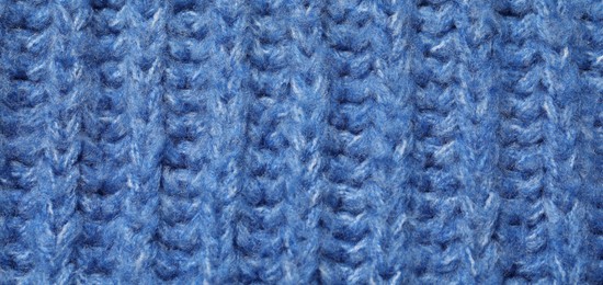 Photo of Texture of soft blue fabric as background, top view