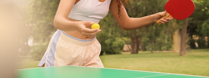 Image of Young African-American woman playing ping pong outdoors. Banner design