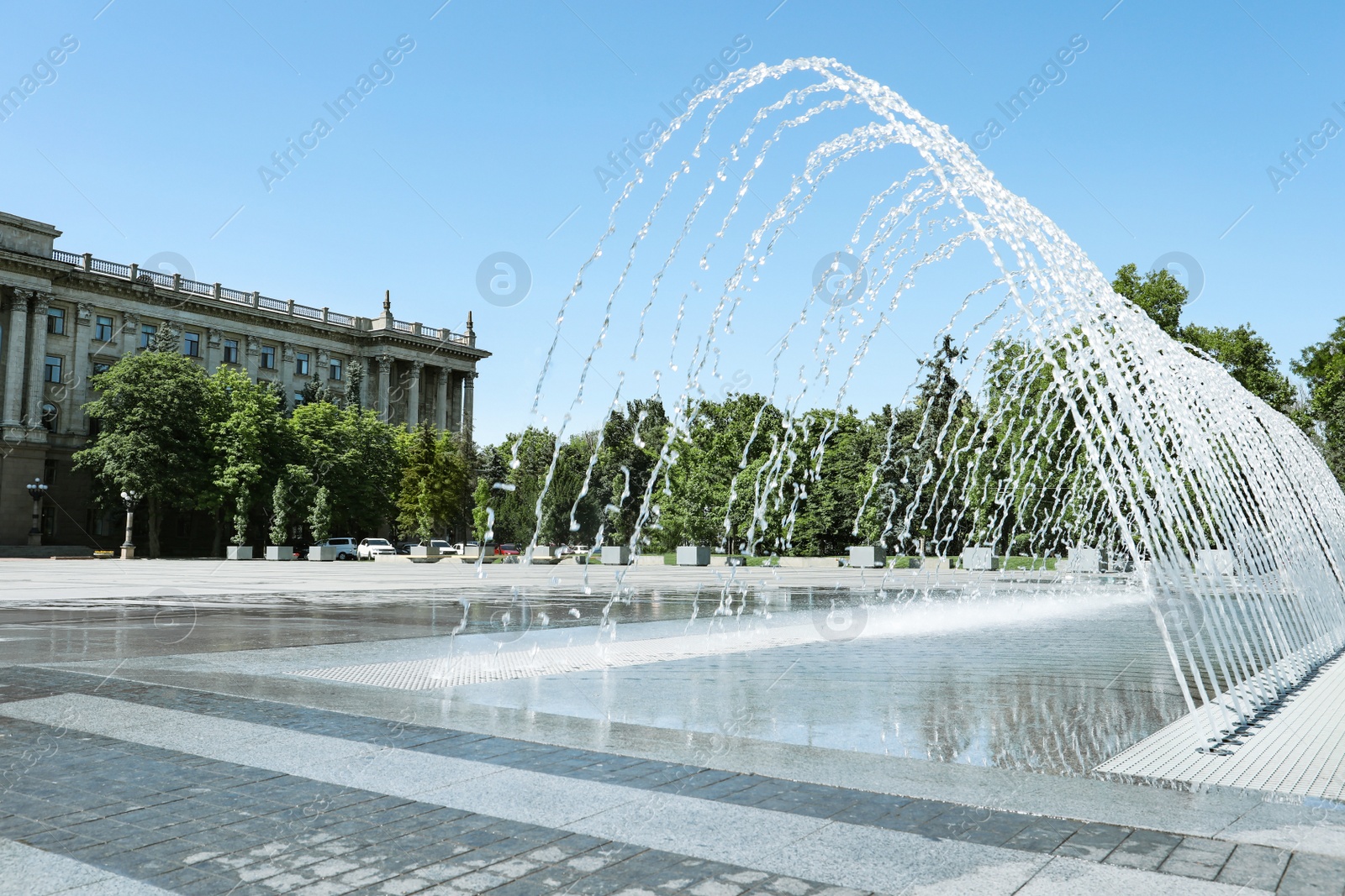 Photo of City square with beautiful fountains on sunny day