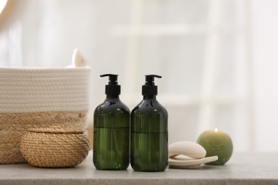 Green soap dispensers on white countertop in bathroom