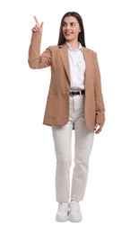 Beautiful businesswoman in suit pointing at something on white background