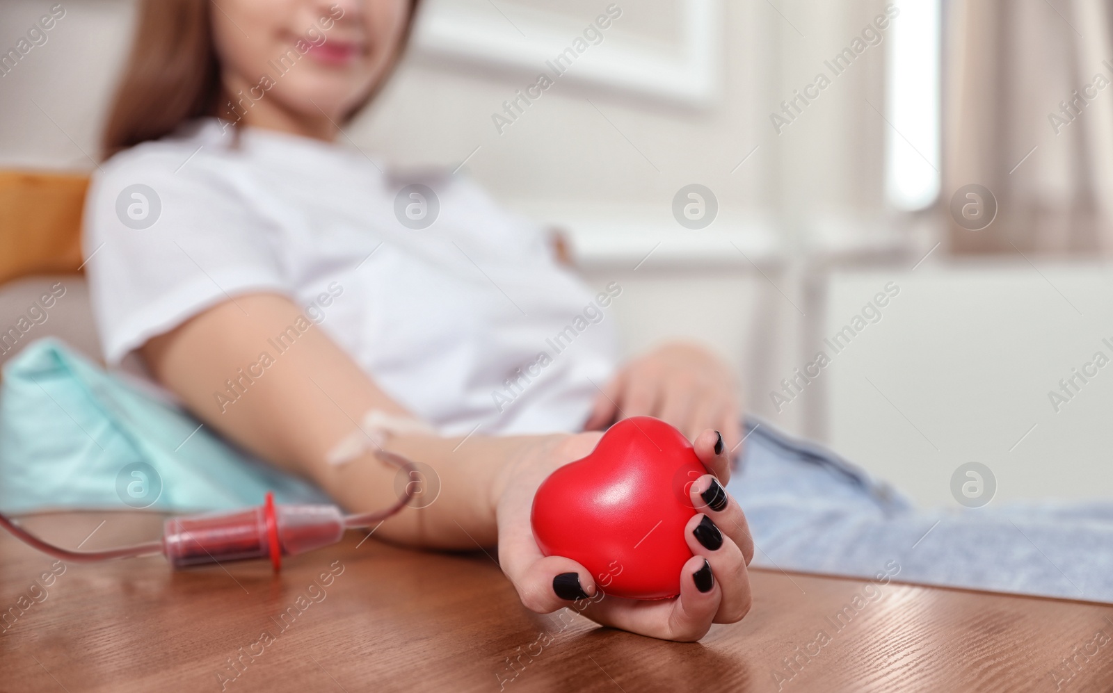 Photo of Teenager donating blood in hospital, closeup view