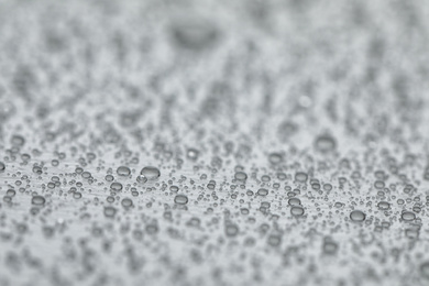 Water drops on grey background, closeup view