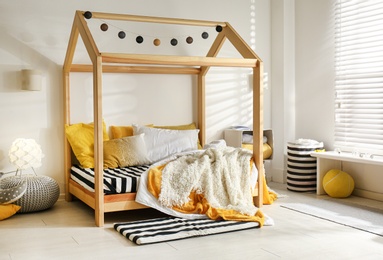 Photo of Cozy child room interior with comfortable bed