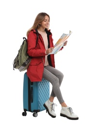 Woman with map and suitcase on white background. Winter travel