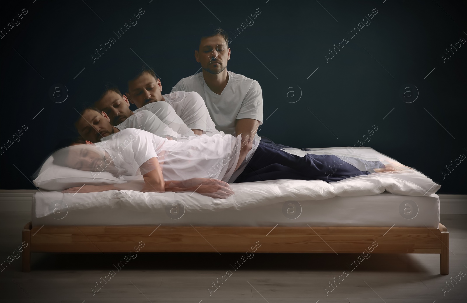 Image of Somnambulist rising from bed near dark wall indoors, multiple exposure. Sleepwalking