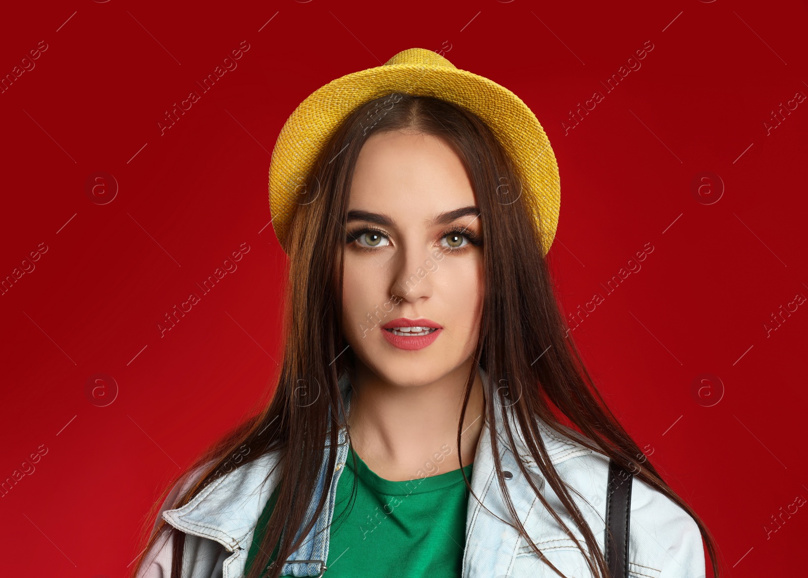 Photo of Portrait of beautiful woman on red background