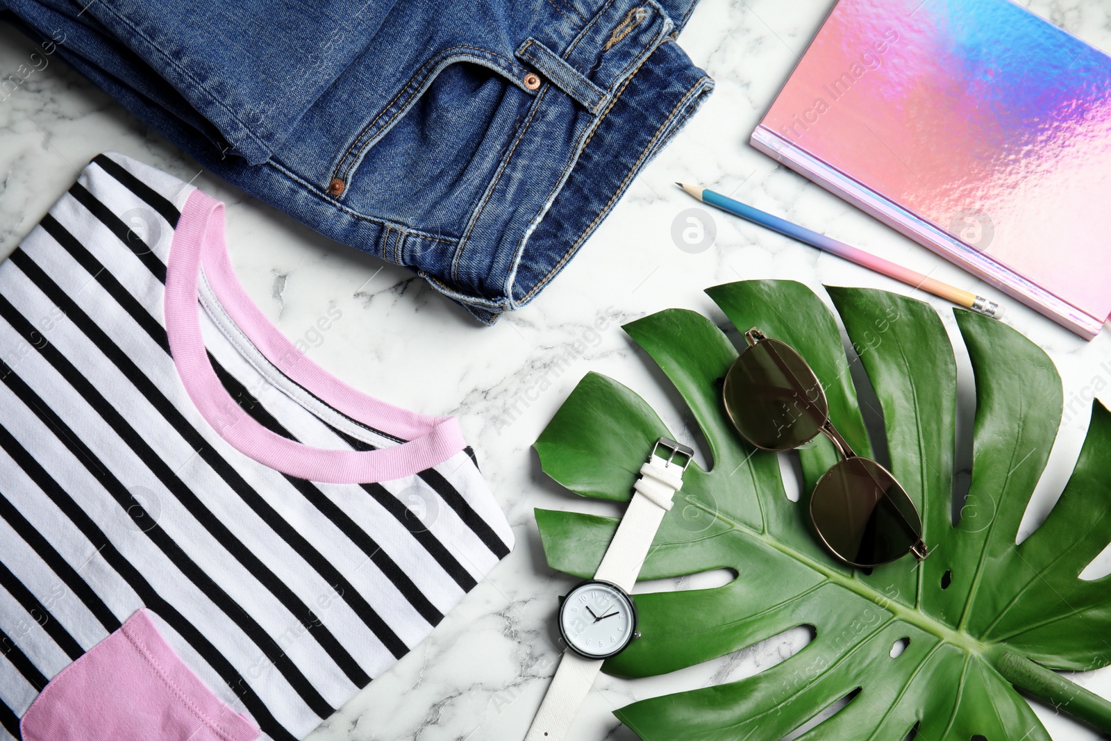Photo of Flat lay composition with stylish clothes and accessories on marble table. Fashion blogger