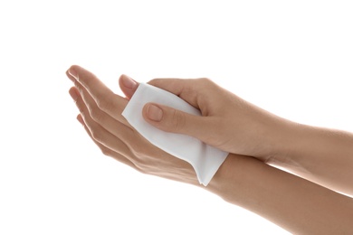 Woman cleaning hands with paper tissue on white background, closeup