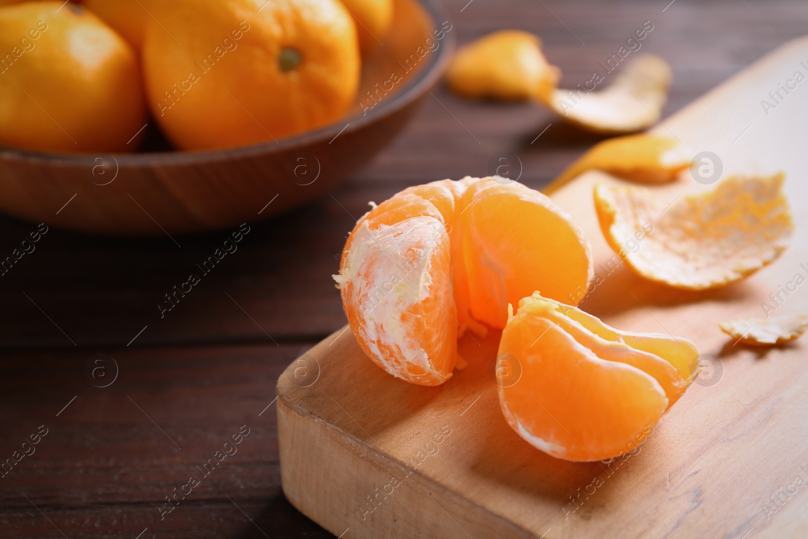 Photo of Fresh tangerines on wooden table. Citrus fruit