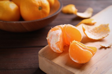 Fresh tangerines on wooden table. Citrus fruit