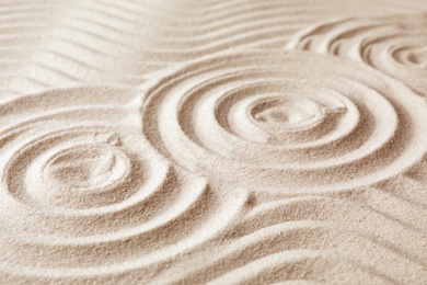 Photo of Zen garden pattern on sand. Meditation and harmony