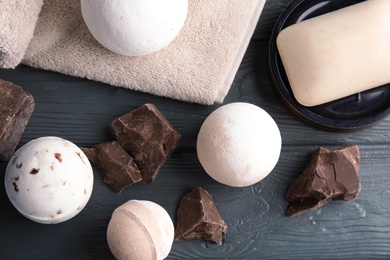 Flat lay composition with bath bombs and pieces of chocolate on table