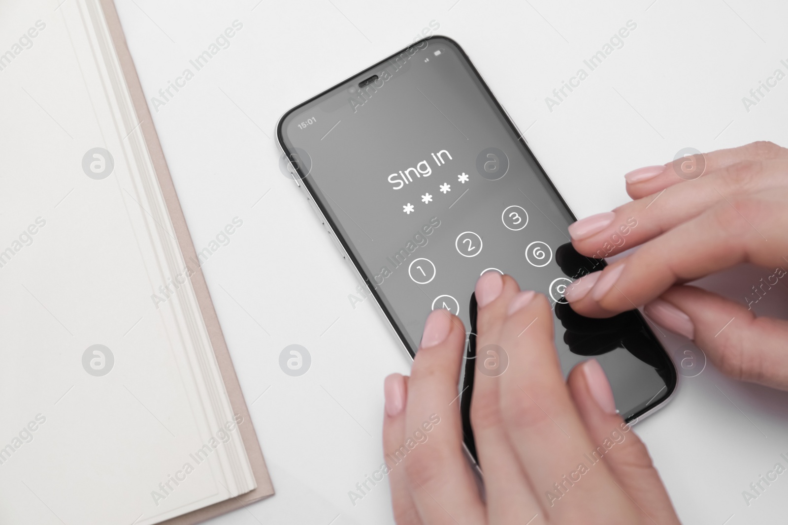 Photo of Woman unlocking smartphone with blocked screen at white table, closeup