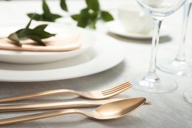 Photo of Cutlery and blurred plates with napkin on table