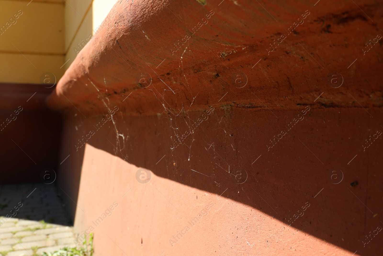 Photo of Cobweb on old building outdoors on sunny day