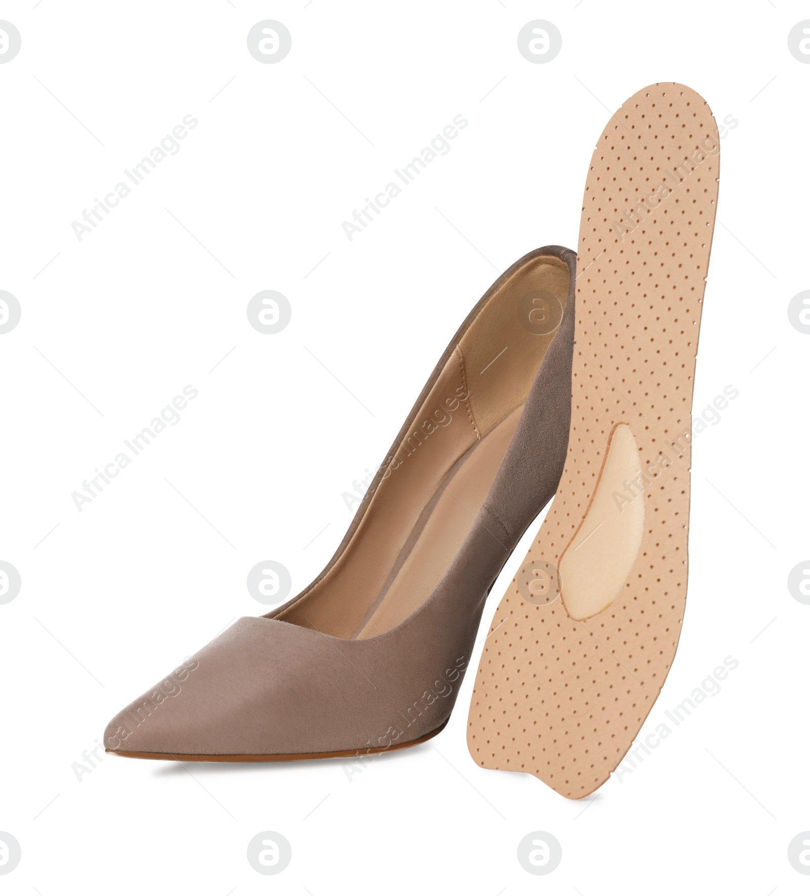 Photo of Orthopedic insole near high heel shoe on white background