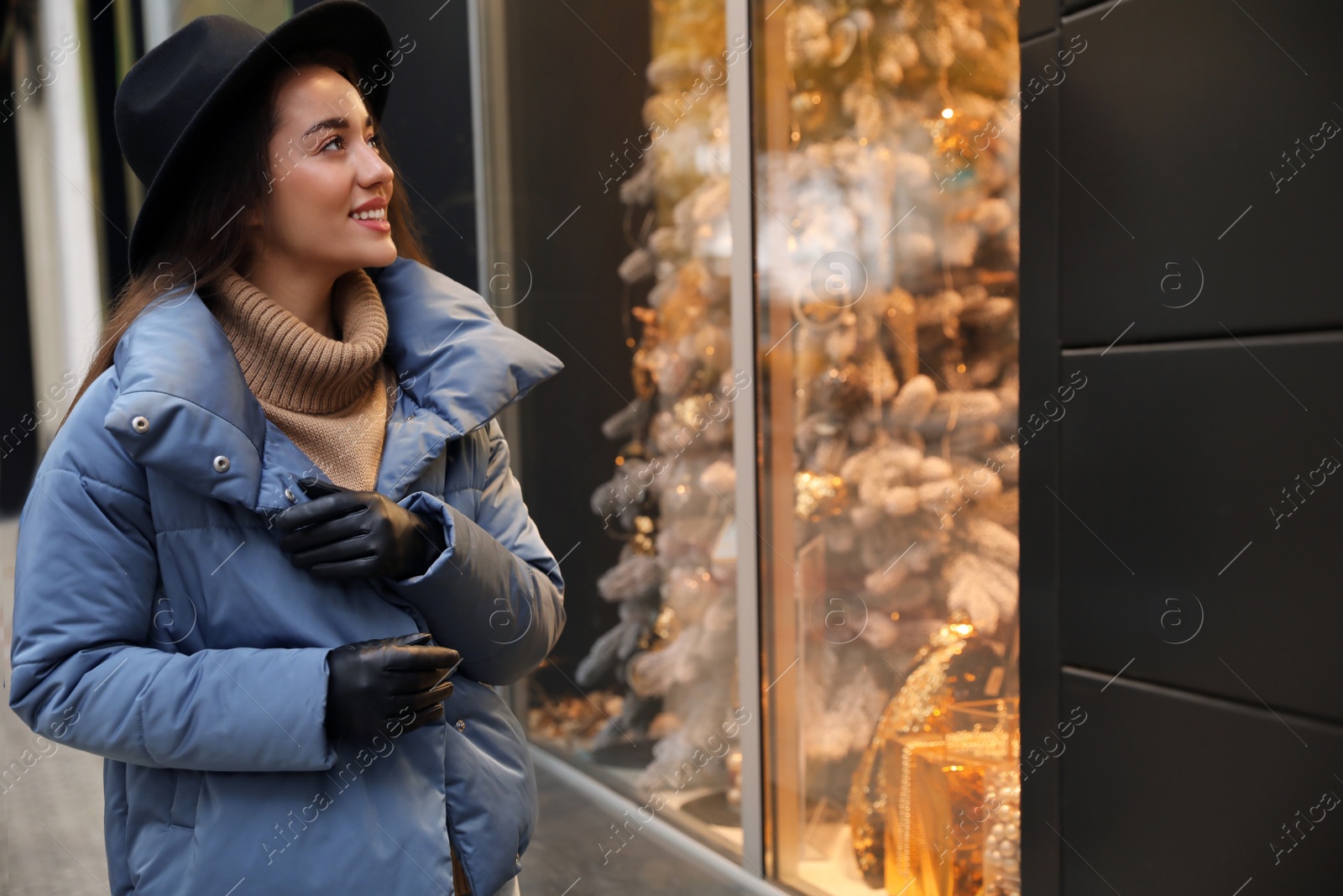 Photo of Young woman wearing stylish clothes on city street, space for text. Autumn look