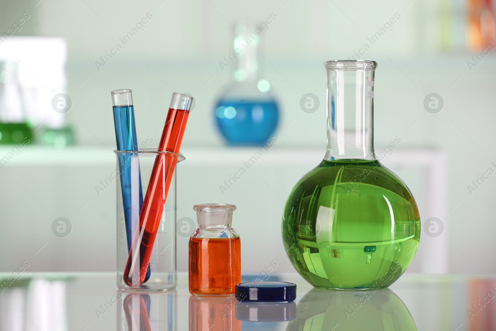 Photo of Laboratory analysis. Different glassware with liquids on white table indoors