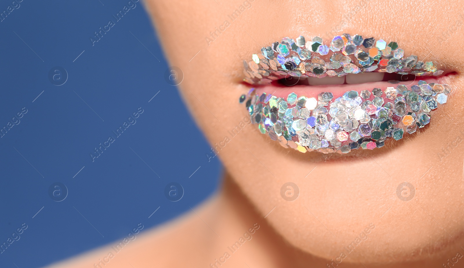 Photo of Beautiful young model with extravagant lips makeup on color background