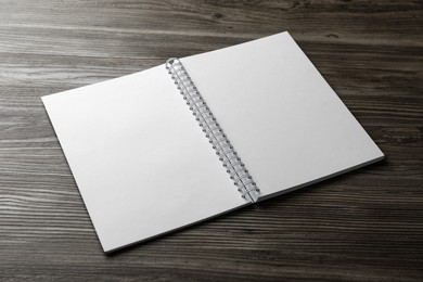 Photo of Blank paper brochure on wooden table. Mockup for design