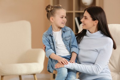 Photo of Little girl with her mother spending time together at home