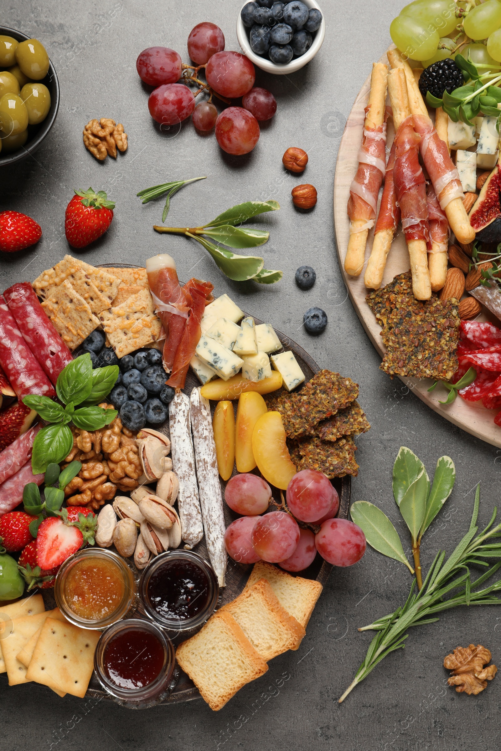 Photo of Different tasty appetizers on dark grey table, flat lay