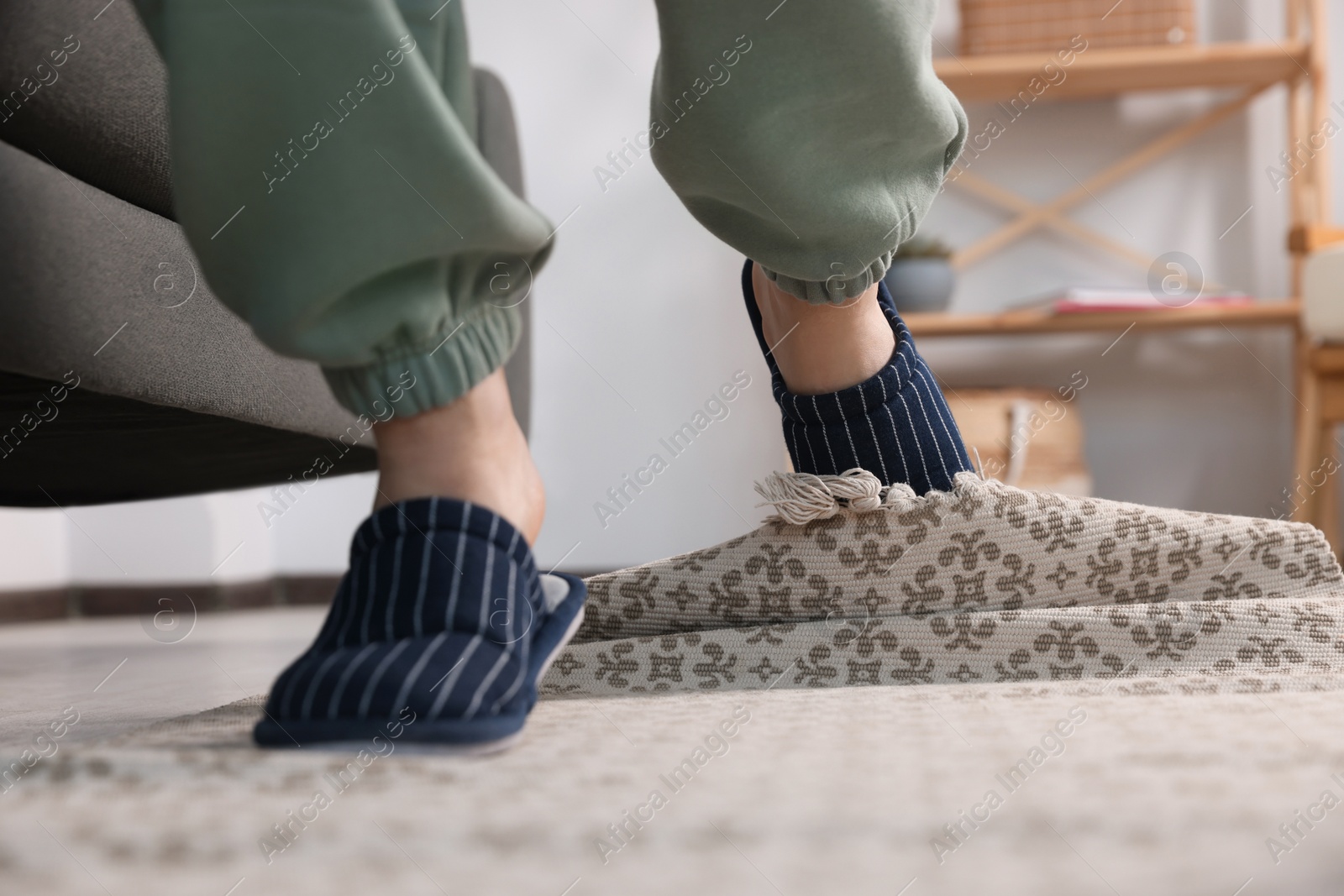 Photo of Man tripping over rug at home, closeup